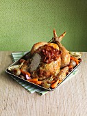 Roast chicken with bacon and a side of vegetables, sliced