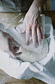 Bread dough being covered with a cloth