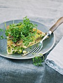 Frittata with peas and potatoes on a grey porcelain plate