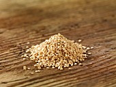 A pile of quinoa on a wooden surface