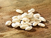 White beans on a wooden surface