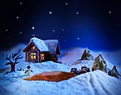 A winter landscape made from sugar with a gingerbread house