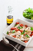 Baked fish fillets with tomatoes, basil, capers and pine nuts