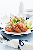 Fish cakes with lettuce and limes (Thailand)