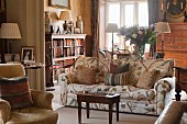 Seating area with sofa and armchairs in English manor house