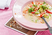 Vegan peanut soup with vegetables and garden cress