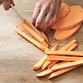 Sweet potato being cut into chips