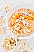 Pancakes with peaches and crunchy muesli