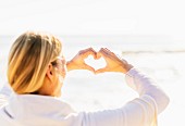 Woman making heart shape with hands