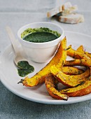 Oven-baked pumpkin wedges with pumpkin seed pesto
