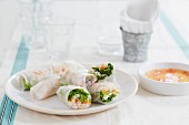 Rice paper rolls filled with carrots, rice noodles, shrimps and chilli dip (Vietnam)