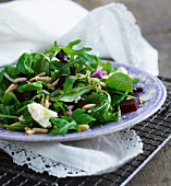 A mixed leaf salad with beetroot, pine nuts and goat's cheese