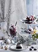 A table laid for Christmas with sugared fruits, pralines and champagne