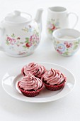 Chocolate cupcakes with raspberry frosting served with tea