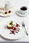 White and dark chocolate dessert with raspberries, coffee and truffle pralines