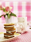 A stack of oat sandwich biscuits filled with cream cheese