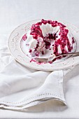 Ice cream cake with berry sauce on a vintage plate
