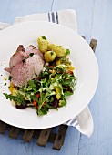 Slices of roast veal with a colourful salad and new potatoes