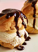 Profiteroles with chocolate sauce and vanilla ice cream (close-up)