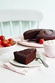 Chocolate cake served with strawberries and cream