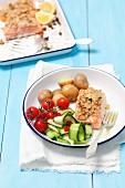 Baked salmon with a horseradish crust, potatoes, cherry tomatoes and courgette
