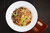 Oriental egg noodles with carrots, spring onions and duck