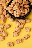 Goldfish crackers in a black bowl on a yellow surface