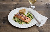 Salmon fillet with bean sprouts on a cucumber salad with a heart-shaped piece of bread