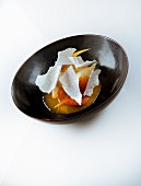 A dessert with candied citrus fruits and meringue chips