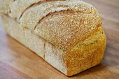 A loaf of white bread on a wooden table