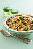 Couscous with sweet potatoes, green asparagus and pomegranate seeds