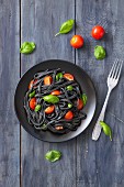 Black squid ink pasta with tomatoes and basil