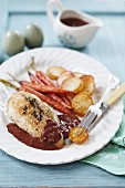 Roast chicken breast with carrots, roast potatoes and red wine gravy