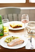 Grilled salmon fillet with pepper and mint potatoes served with rose wine and beer