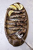 Grilled sardines with lemon wedges (Portugal)