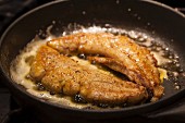 Spiced, fried allis shad roe in a pan
