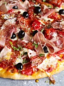 Pizza with salami, Parma ham and smoked ham