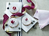 Shortcrust tartlets with berry cream and icing sugar