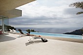 Purist ambiance on sun terrace with infinity pool and panoramic sea view