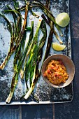 Grilled spring onions with a dip