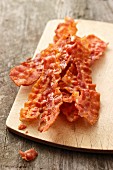 Crispy fried bacon on a chopping board