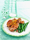 Orange drumsticks with rice & green beans
