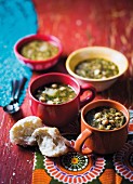 Onion and chickpea soup with white cabbage in cups and bowls