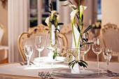 Festive place settings decorated with calla lilies and oleander