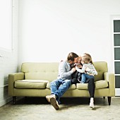 Family cuddling on sofa