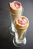 Puff pastry cones filled with creamy rhubarb parfait in two glasses