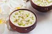 Rabri in a bowls (rice pudding with pistachios and almonds, India)