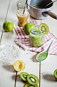 Cold kiwi soup in a glass with limes and honey