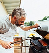 A man barbecuing on his balcony