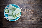 Cucumber and lemon ice lollies (seen from above)